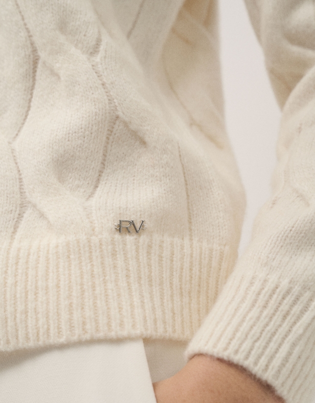 Ivory knit sweater with cable-stitching